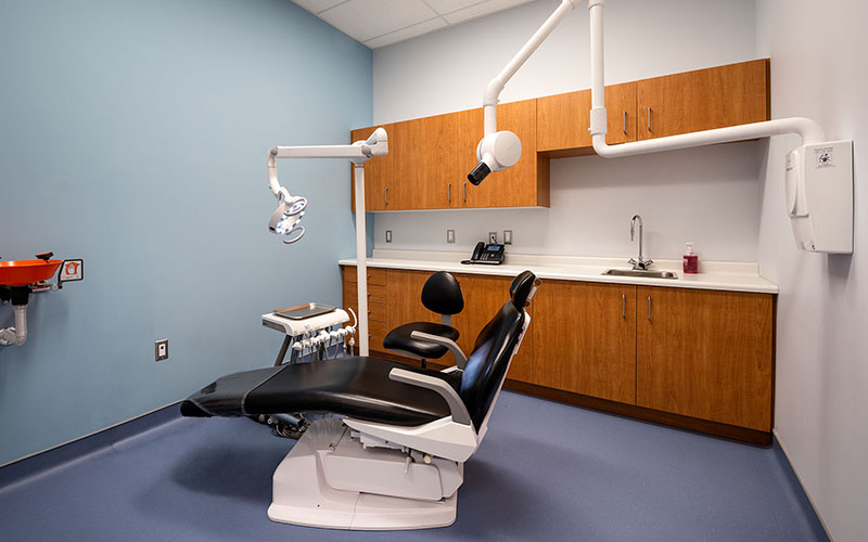 Middlesex London Health Unit, dentist Area with chair for patients and back wall has cabinets on it.