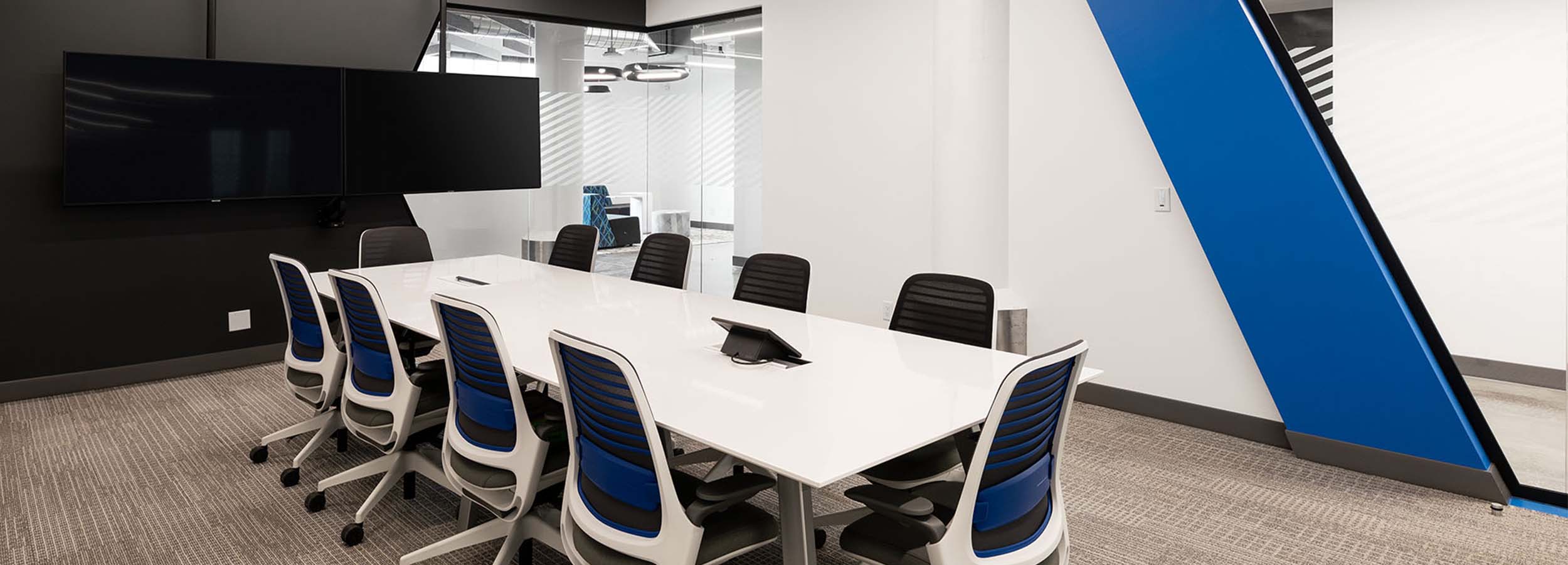 Boardroom table with chairs around it